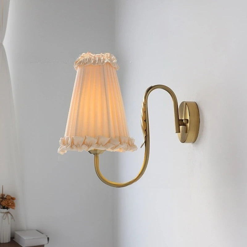 Wall light with ruffled pleated fabric shade and curved wall bracket