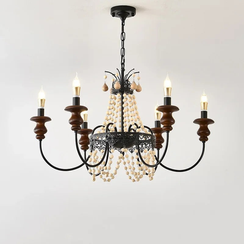 Candle-style chandelier with black metal frame, dark wood candle holders, and bead tassels