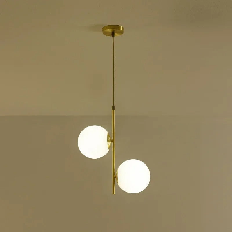 Gold globe pendant light with two white glass shades