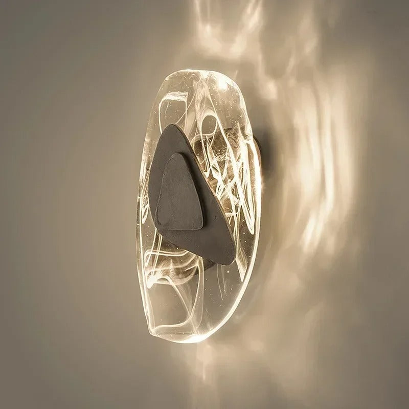 Layered egg wall light with black inner shade and warm glowing diffuser