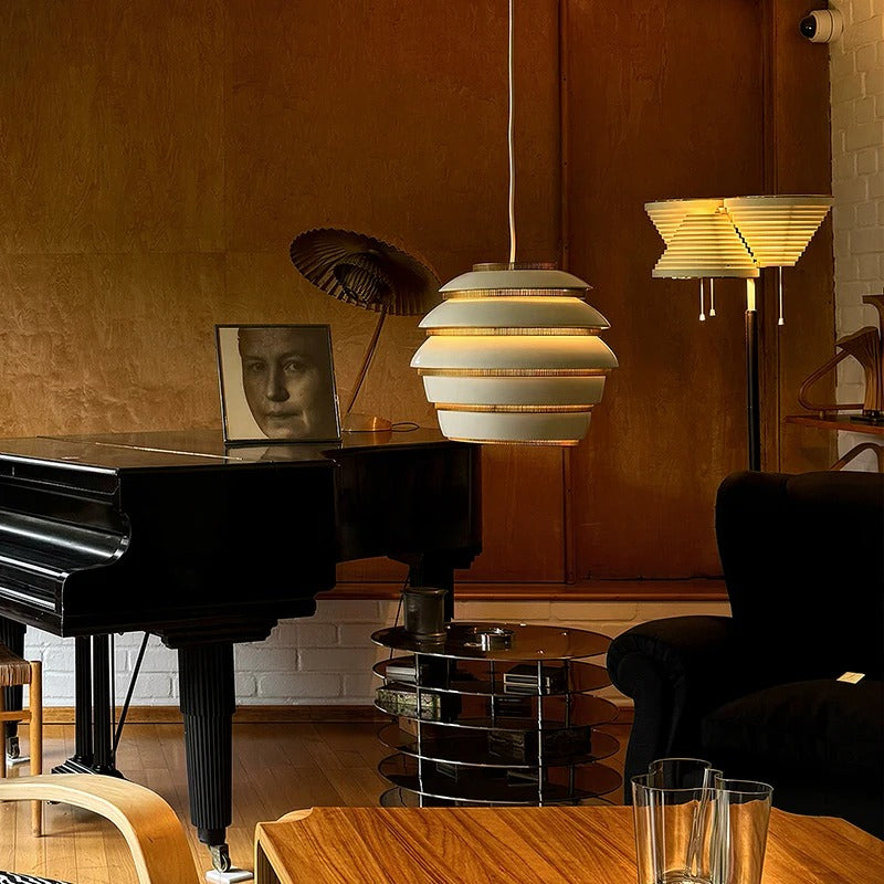 Layered beehive pendant light with glowing white bands and gold-edged rings