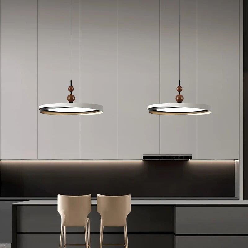 Two ring LED disc pendants with wooden bead accents and round shades hanging from cords