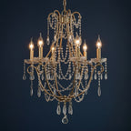Gold-tone candle chandelier with curved frame and dangling beaded teardrop chains