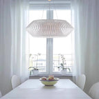 White diamond tapered hanging chandelier with open lattice shade above a table