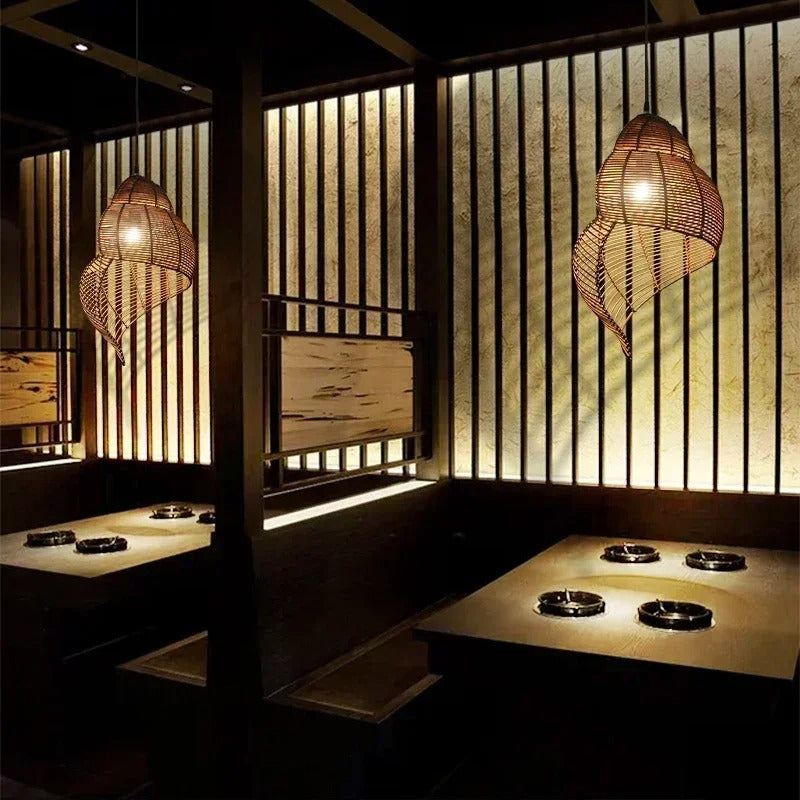 Woven rattan spiral shell pendant lights, curved cage shades with warm illumination