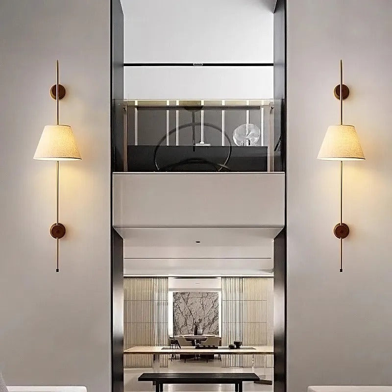 Pair of wall-mounted lights with tapered fabric shades and round brass back plates