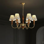 Multi-arm hanging chandelier with floral shades and gold-tone curving arms