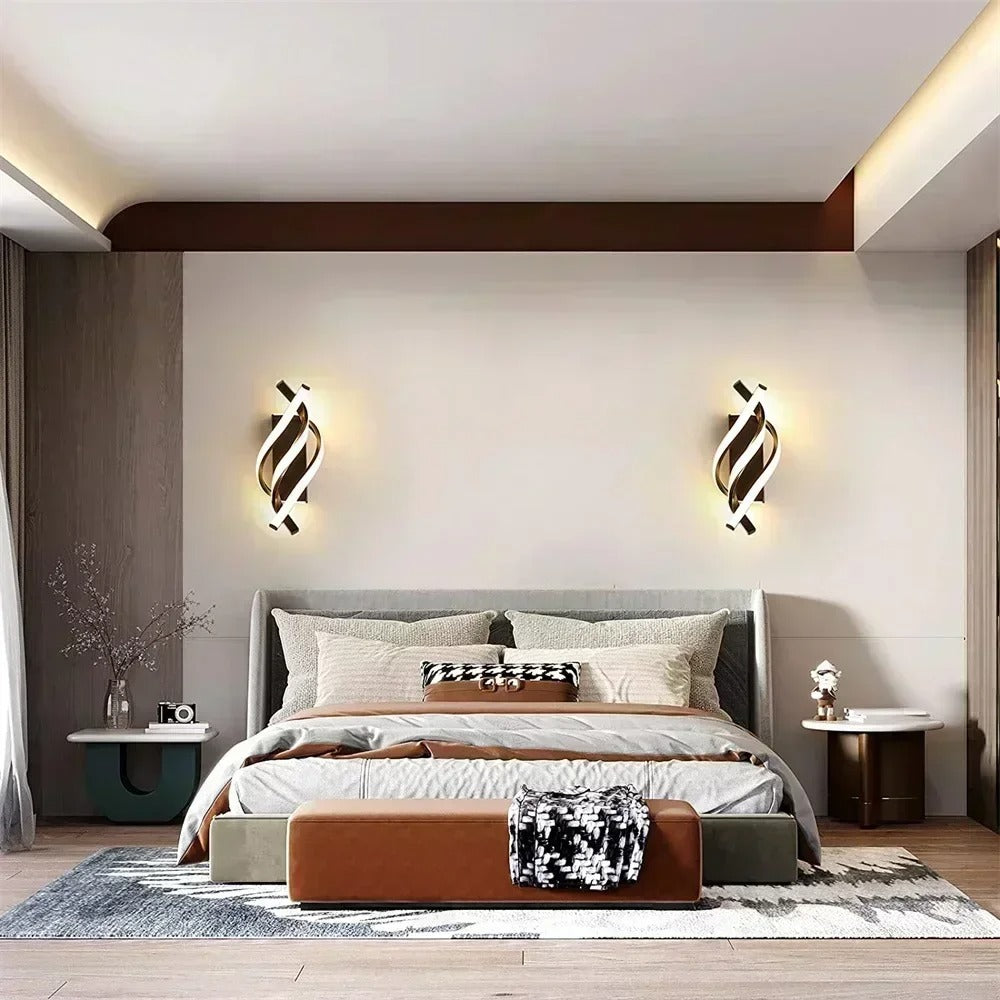 Twisted spiral wall sconce pair with warm light, dark curved metal bodies, wall-mounted.