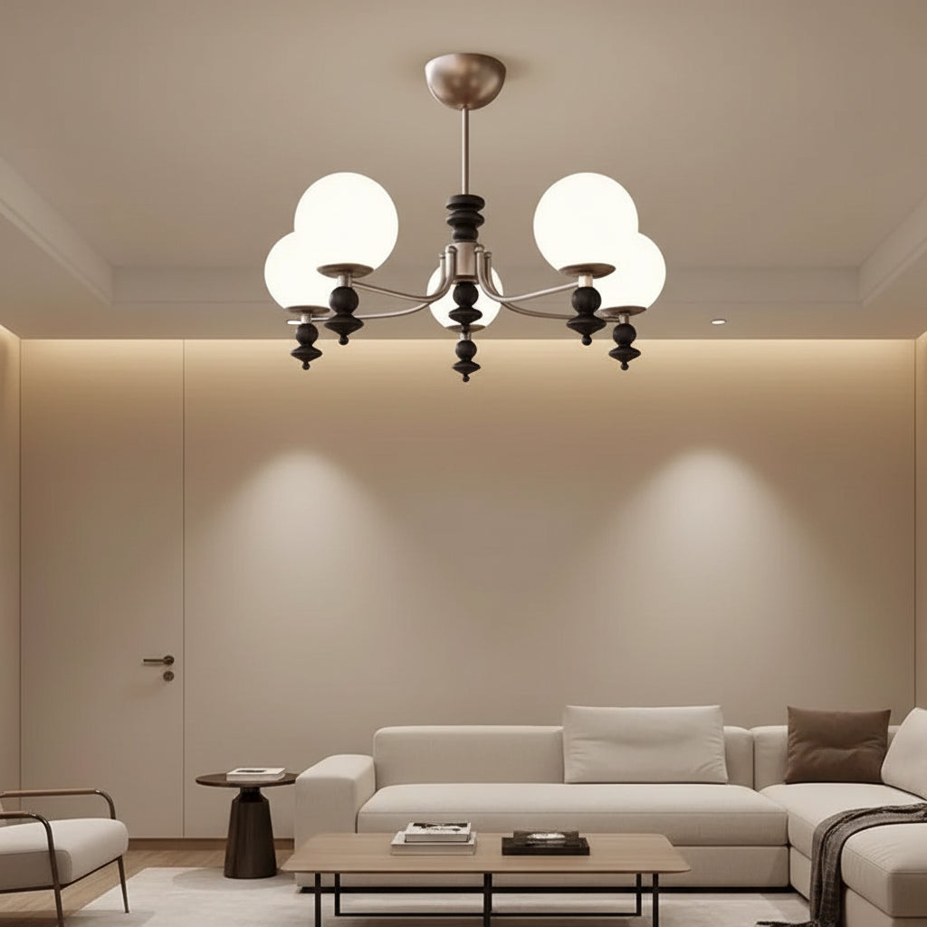 Multi-arm globe chandelier with five white glass shades and black finial accents