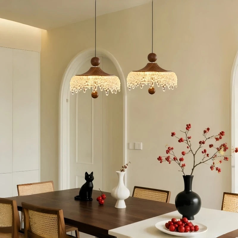 Textured gold dome drop pendant light with brown cord and scalloped fringe shade