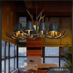 Antler bell shade chandelier with multiple dark shades and warm glowing bulbs