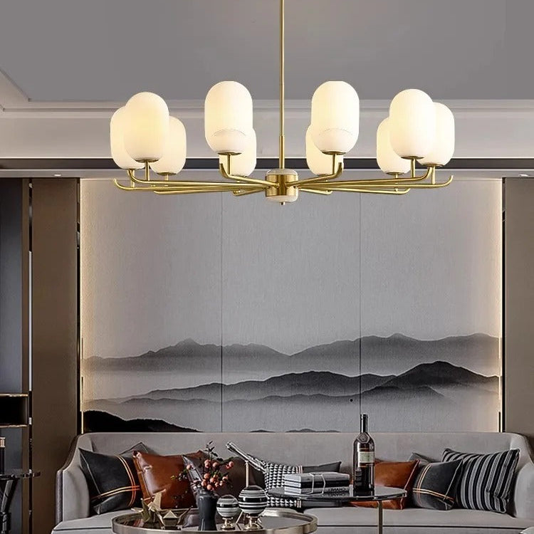 Gold multi-arm chandelier with white glass globe shades and a central stem