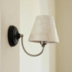 Capiz shell conical wall light with black backplate and off-white conical shade