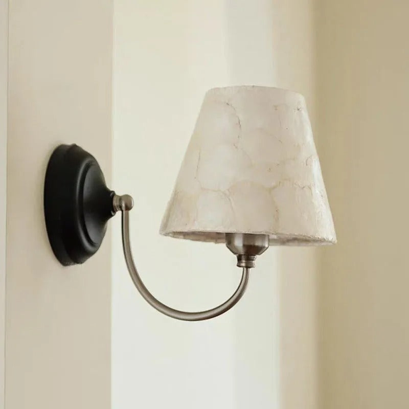 Capiz shell conical wall light with black backplate and off-white conical shade
