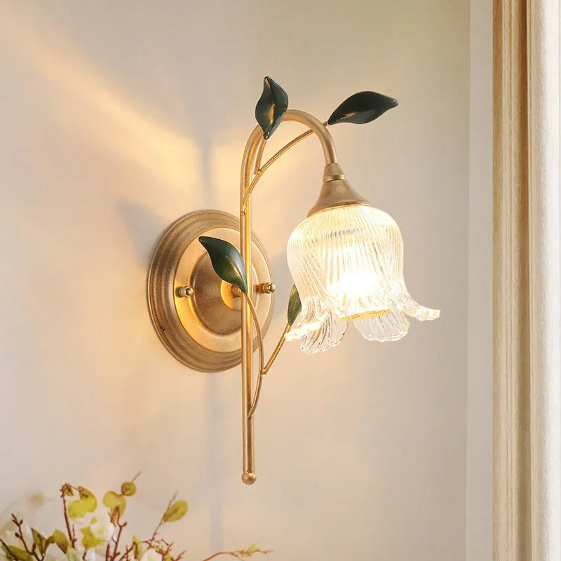 Brass wall light with frosted glass shade and leaf accents