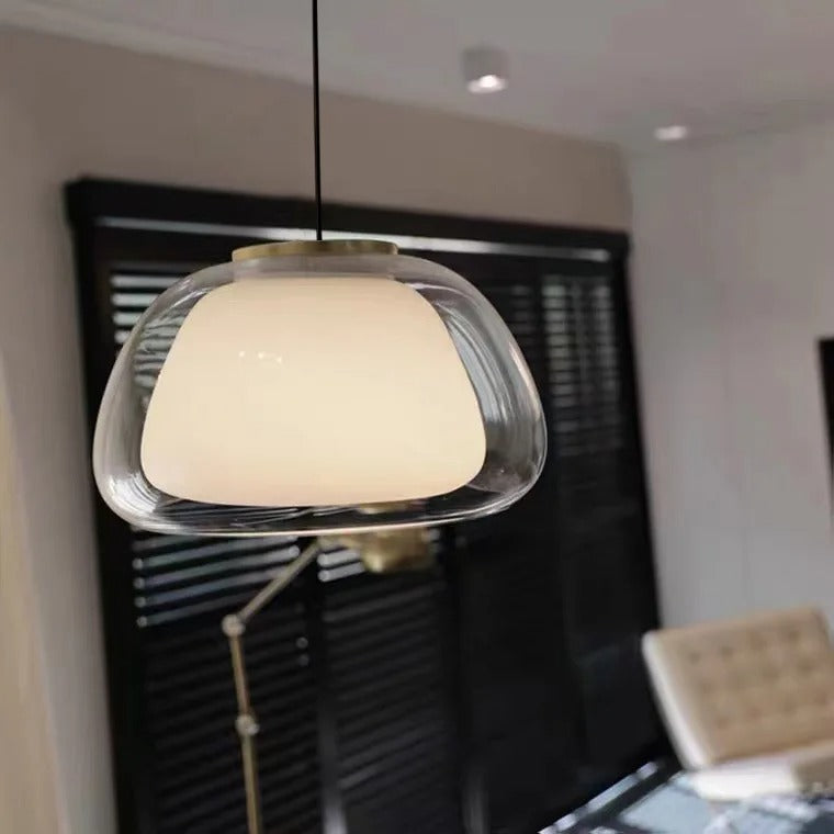 Nordic tinted glass pendant light with clear glass dome shade and warm glow
