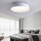 White shallow dome ceiling light with glowing circular diffuser