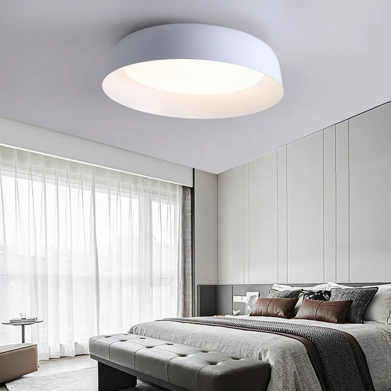 White shallow dome ceiling light with glowing circular diffuser
