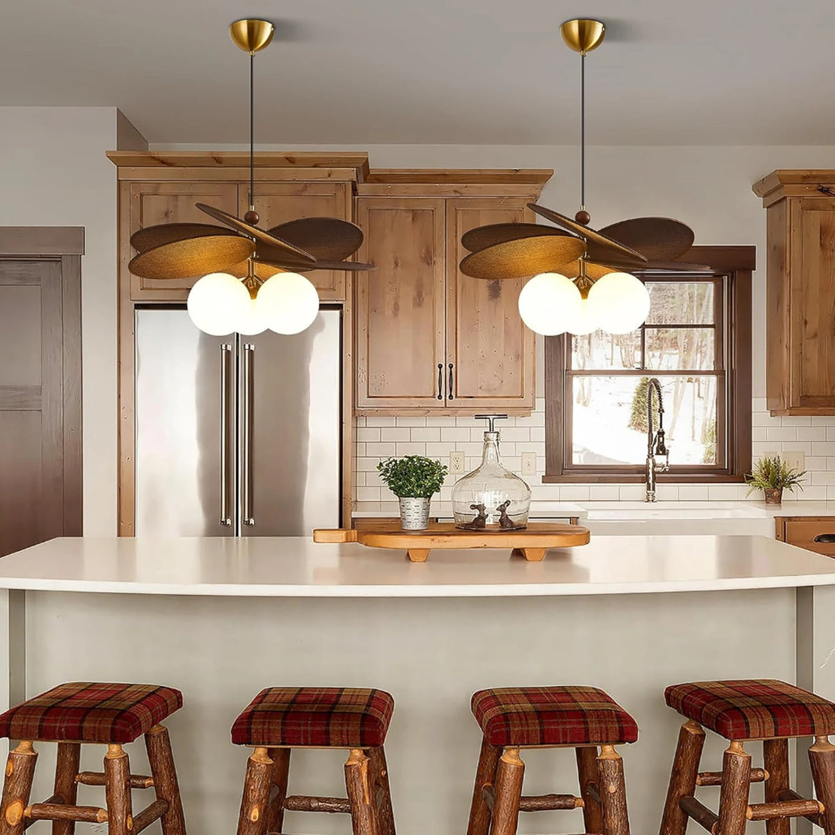 Set of opal globe pendant lights with brass caps hanging over kitchen island