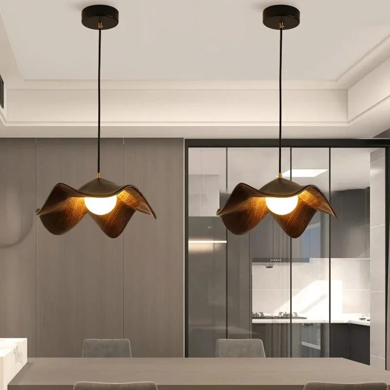 Two brown curved petal pendant lights with warm white glow