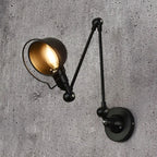 Black swing arm dome wall light with lit amber bulb and round wall mount
