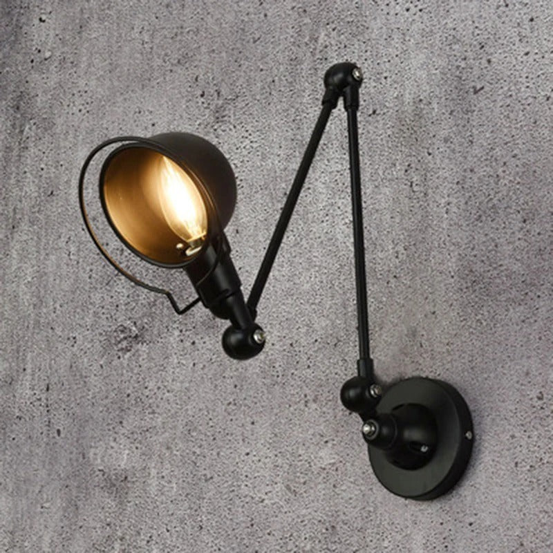 Black swing arm dome wall light with lit amber bulb and round wall mount