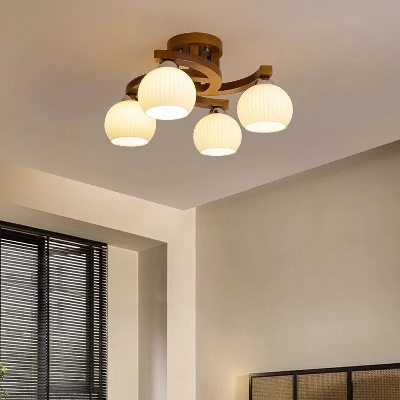 Curved ribbed globe ceiling light with 4 warm glass shades and dark brown metal base