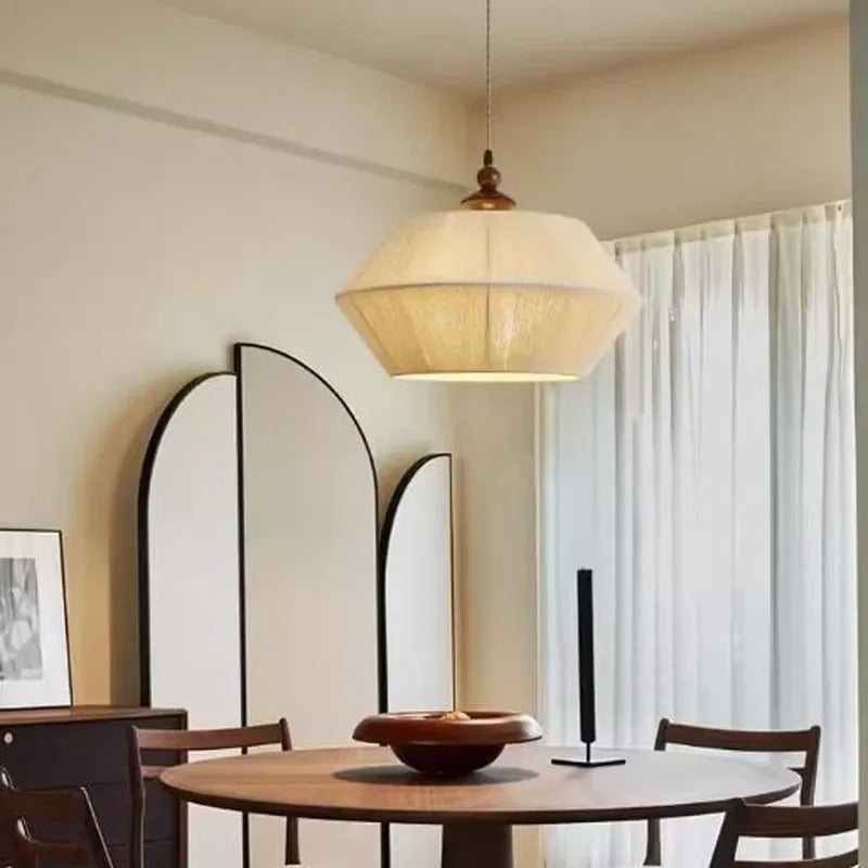 Hexagonal wood pendant drum light with braided cord and warm white glow