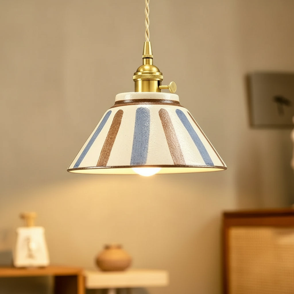 Ceramic conical pendant light with vertical stripe pattern shade and brass ceiling fitting