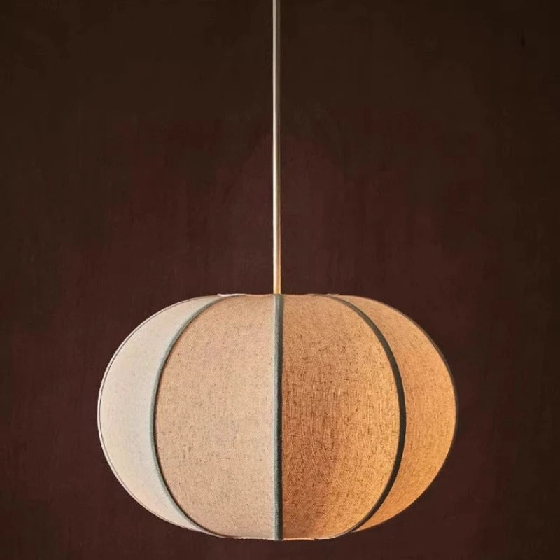 Segmented circular pendant light with cream and tan panels, vertical seam detail, cord