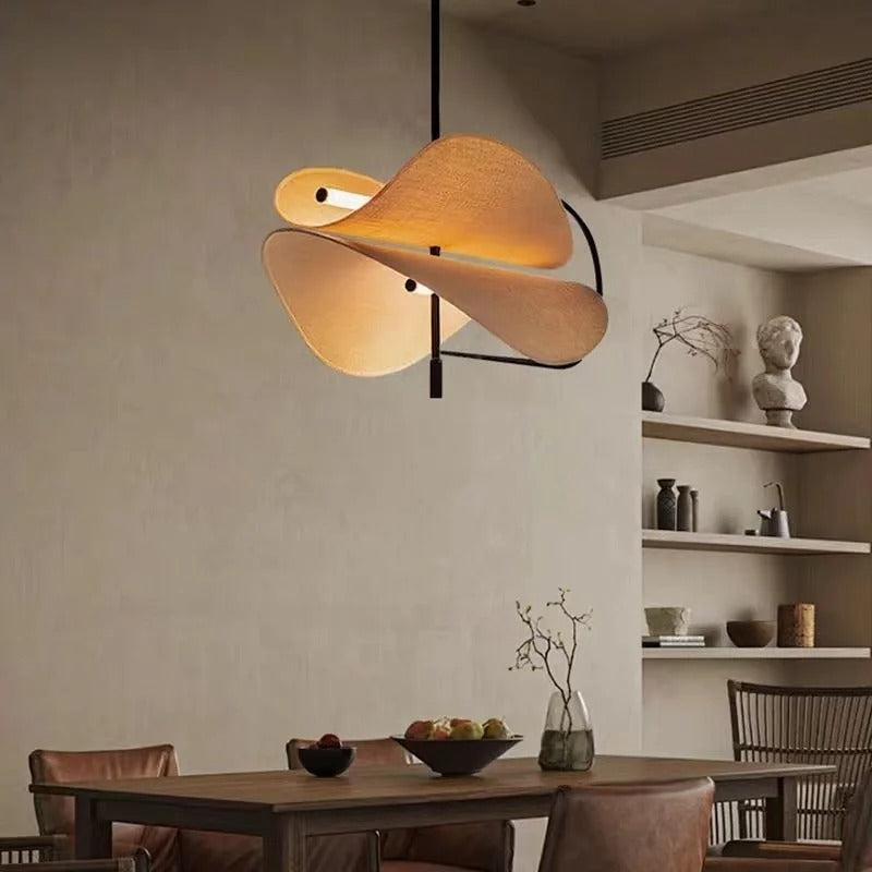 Layered fabric pendant light with tan dome and leaf-shaped shades, black canopy