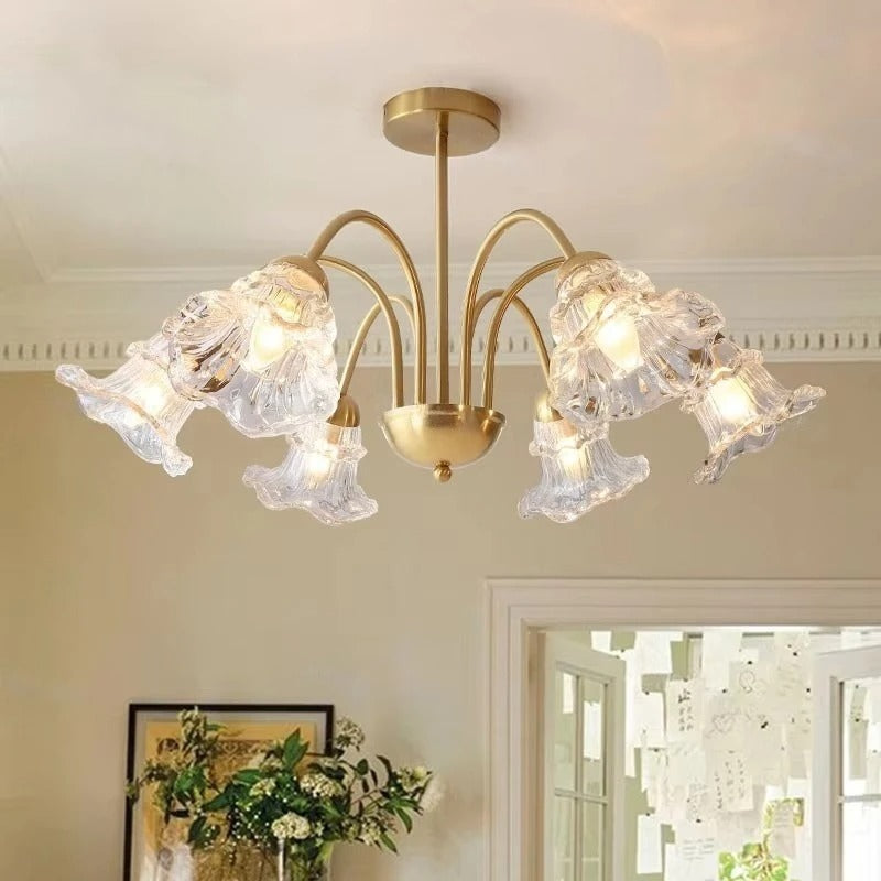 Brass 6-light chandelier with multi-arm flower design and faceted clear glass shades