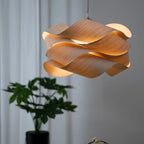 Japandi wood veneer ribbon pendant light with glowing ribbon loops