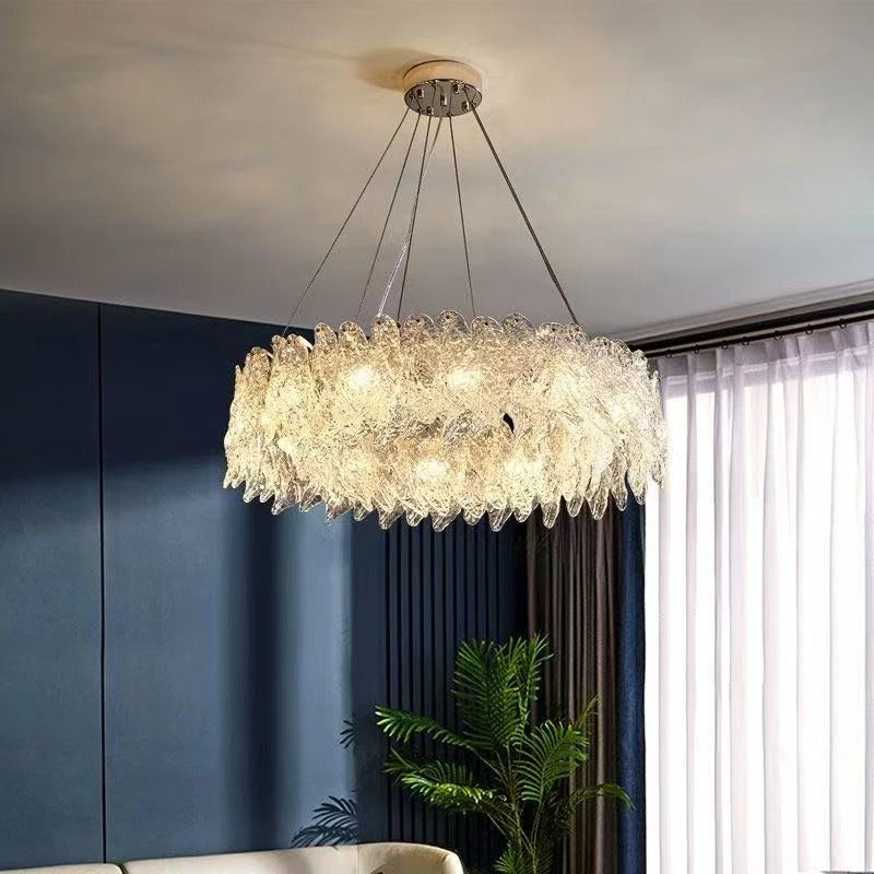 Round tiered crystal chandelier with gold-toned canopy and hanging crystal strands