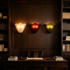 Glowing scalloped wave glass wall lights with cream, red, and green shades and black caps