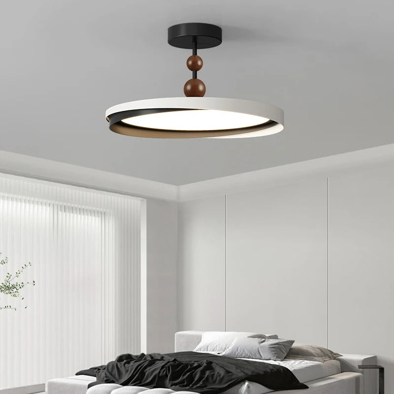 Ceiling light with black canopy, white layered ring, and dark brown spherical hanging accents