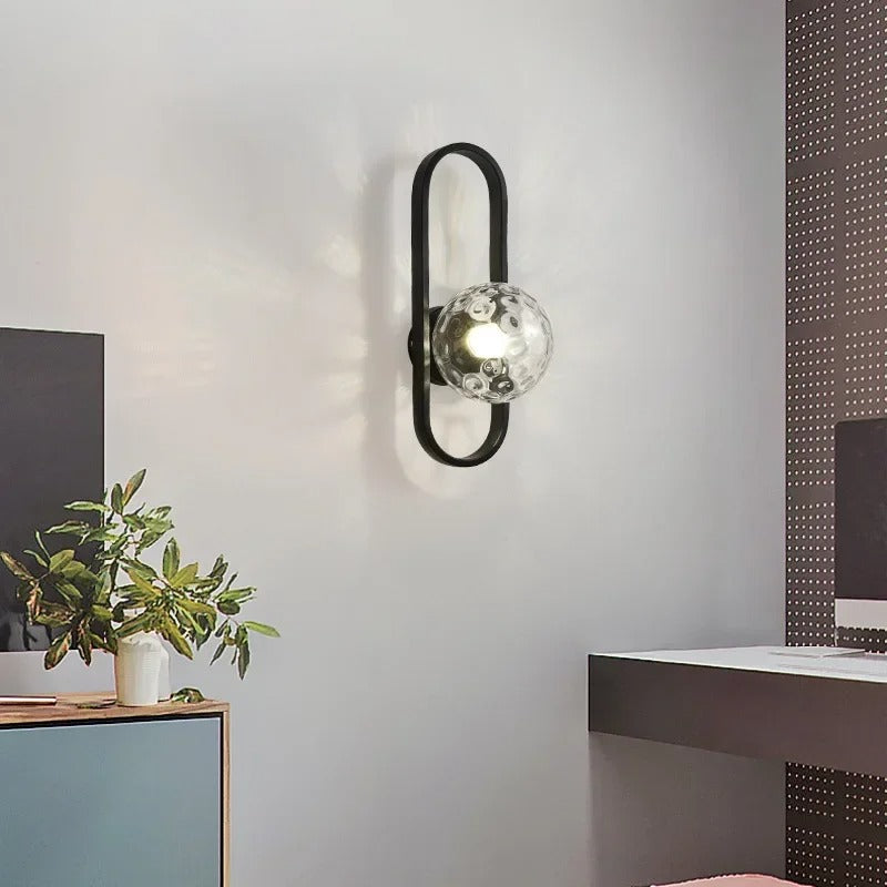Black oval ring globe wall light with clear reflective glass globe