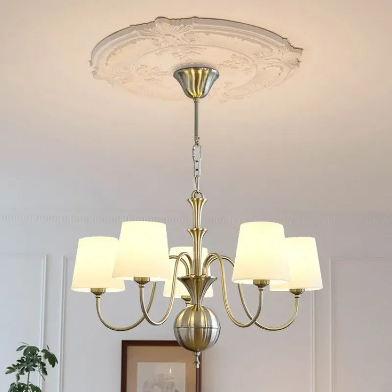 Conical multi-arm chandelier with multiple white drum shades and central finial