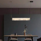 Pendant linear alabaster bar light with glowing white diffuser and gold hanging brackets