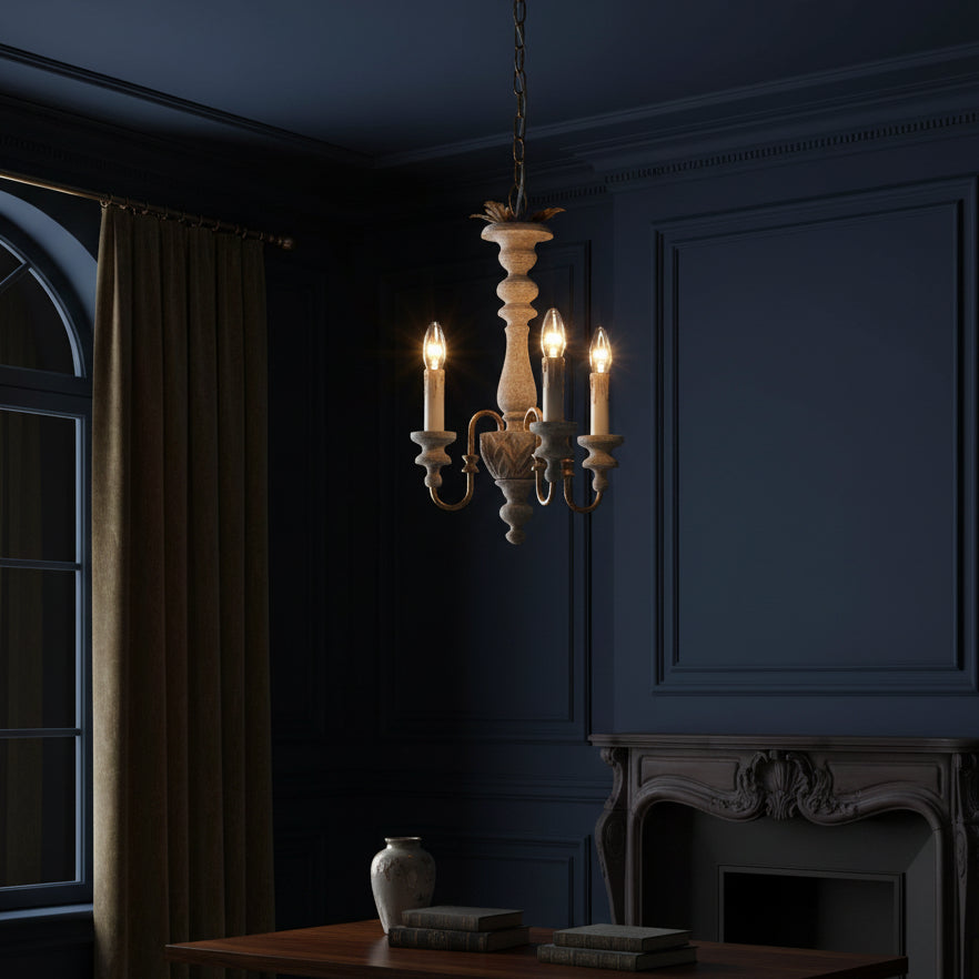 Antique-style spindle chandelier with three lit candle bulbs and curved arms