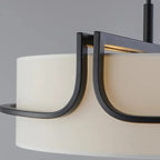 Close-up of open black frame arm and beige fabric drum shade of ceiling chandelier