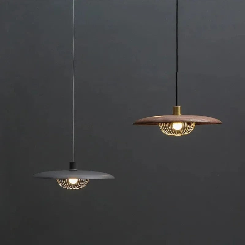 Two hanging saucer pendant lights: dark shade and wood shade with gold wire cages