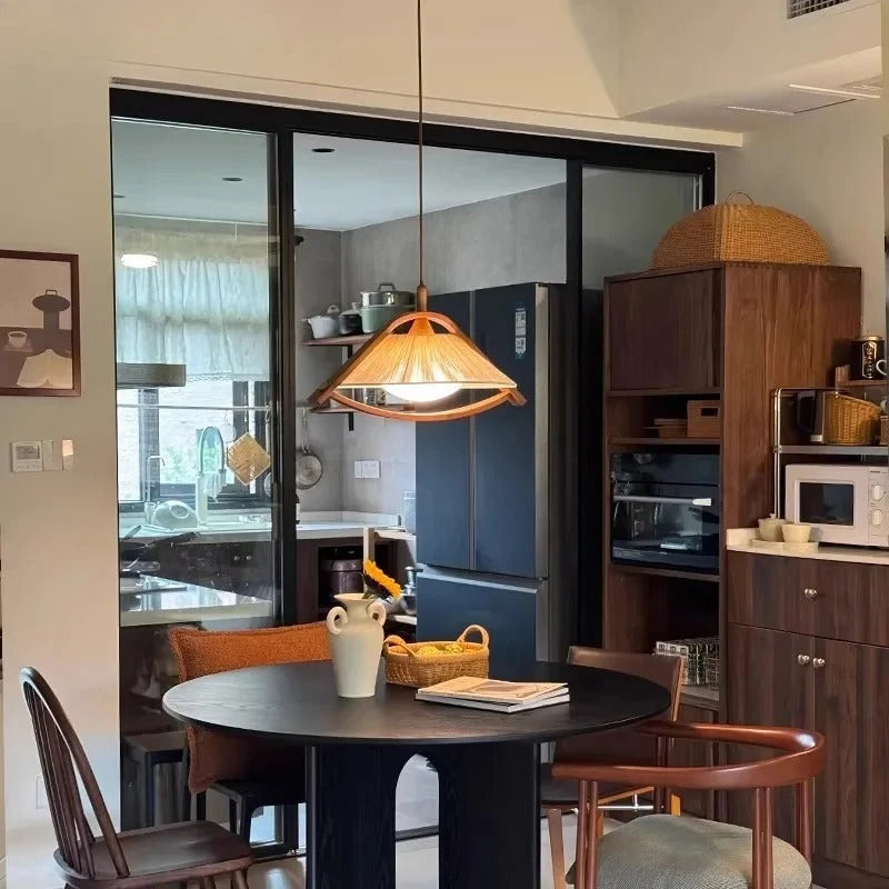 Conical fabric pendant light with warm orange glow and wood-trimmed shade