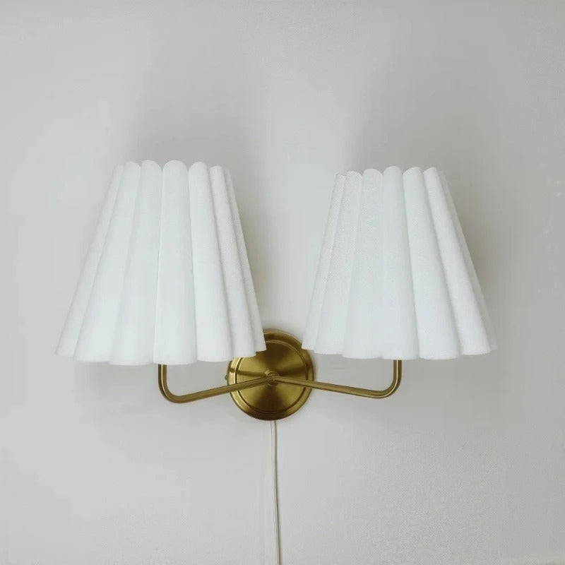 White pleated twin lamp shades with gold-tone curved mounting bar
