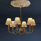 Floral-shade chandelier with central turned wood column and brass-toned arms