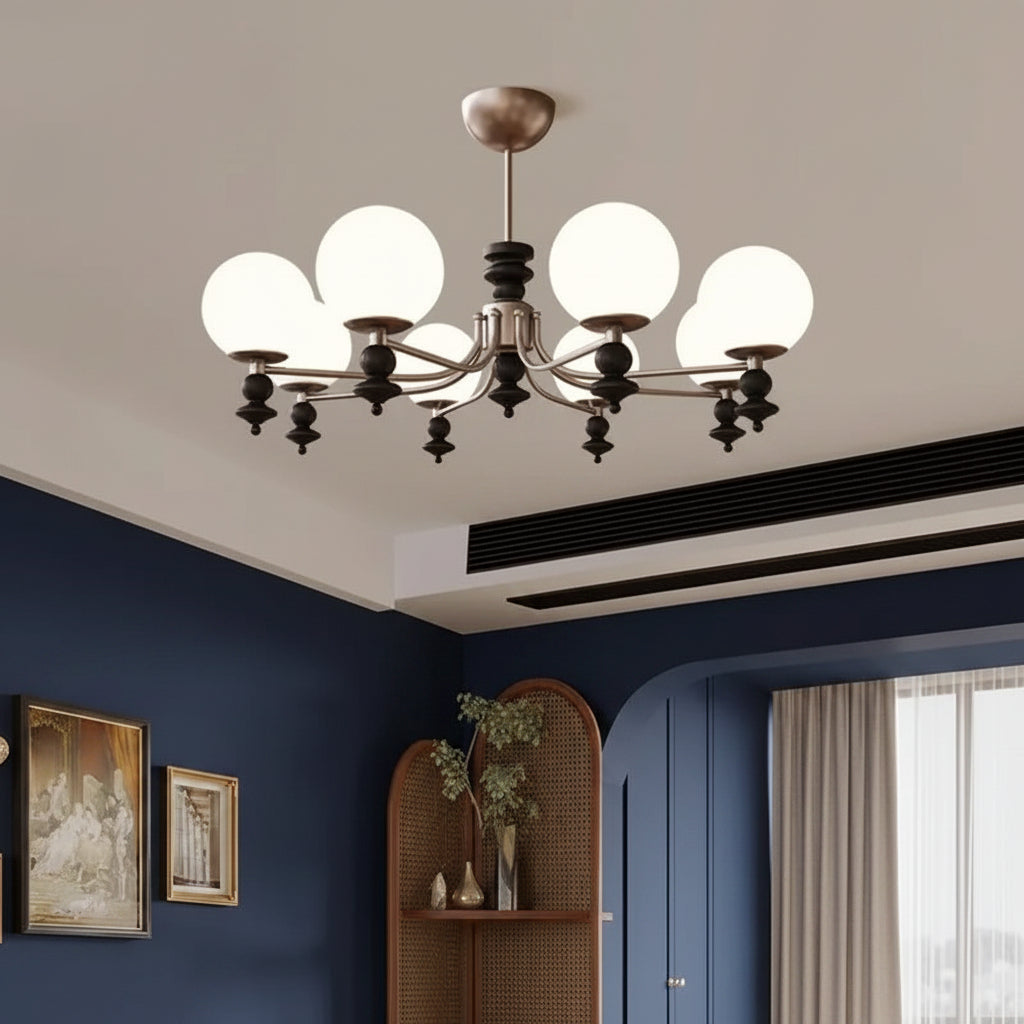 Multi-arm globe chandelier with five white glass shades and dark black finials, arched arms