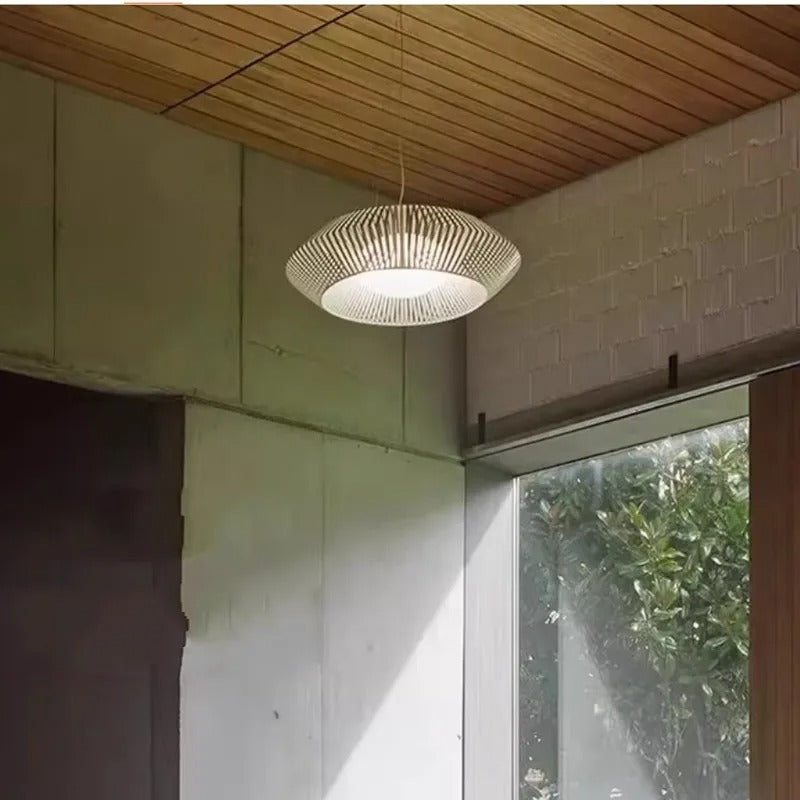 White pendant chandelier with open lattice shade and soft glowing light