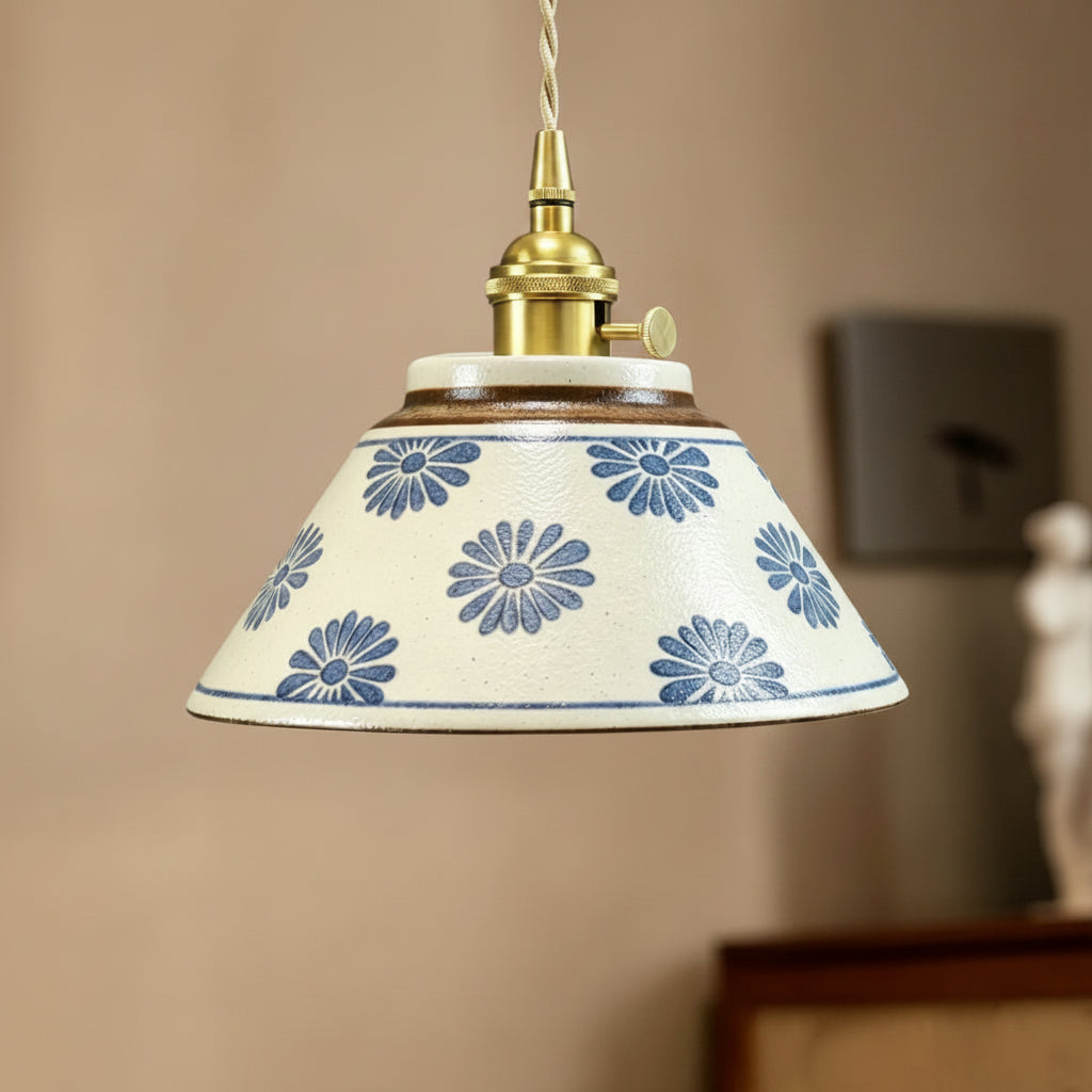Ceramic conical pendant light with blue floral pattern shade and brass pull-cord fitting