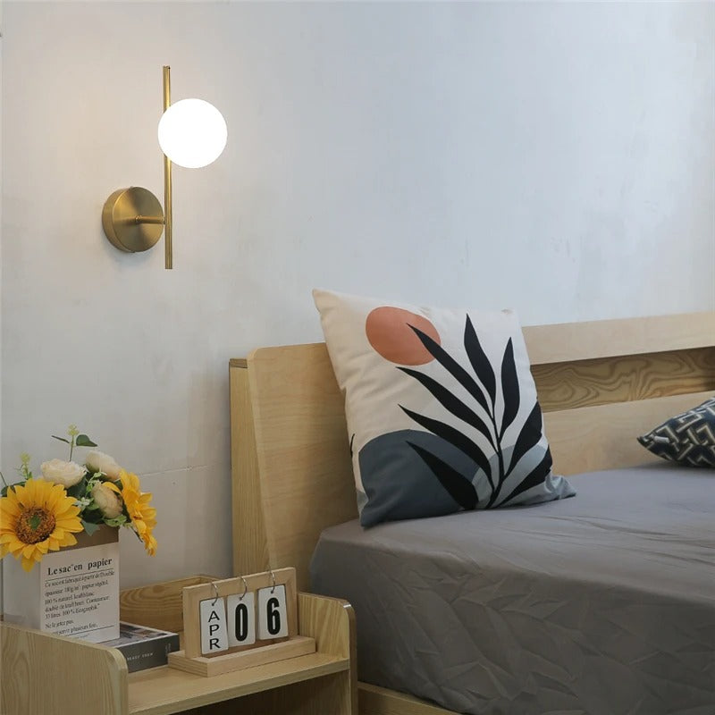 Zuvu Opal Globe vertical wall light with brass backplate and white glass globe