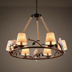 Bird chandelier featuring hemp ropes, black ring base, and warm amber drum lamp shades